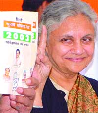 Delhi Chief Minister Sheila Dikshit with the Congress manifesto