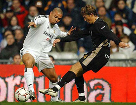 Real Madrids Brazilian Ronaldo (left) fights for the ball against Jose Aranda of Alabacete
