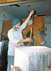 Mohinder Singh checks out a mutton seekh at his shop in Patiala