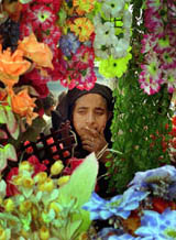 A Kashmiri woman looks at artificial flowers ahead of the Id festival in Srinagar 