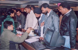 Officials of Reliance Infocom attend to queries at a customers meet organised in Ludhiana on Tuesday.