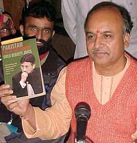 All-India Vishva Hindu Parishad general secretary Praveen Togadia shows a book on Pakistan