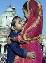 Children greet each other on the eve of Id festival at Jama Masjid in New Delhi 
