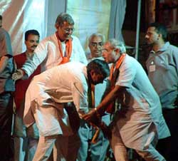 BJP candidate from Bhopal (North) Rameshwar Sharma pays respects to the Gujarat Chief Minister Narendra Modi at an election meeting in Bhopal on Wednesday.