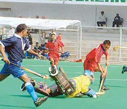 A Mirzoram player tries to score a goal against Delhi during the 52nd All-India Police Hockey Tournament in Jalandhar