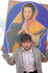 A child supporter with a cut-out of Sonia Gandhi 