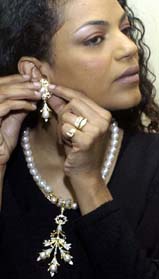 A model adjusts an earring as she poses with a selection of Bridal Asia jewellery at an exhibition in New Delhi on Friday
