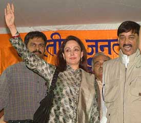 Bollywood actress Hema Malini waves to the crowd during a BJP election meeting in Bhopal