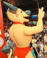 An electronic mascot of the 22nd SEA Games the Golden Buffalo entertains passers-by outside an electronics complex in downtown Ho Chi Minh city