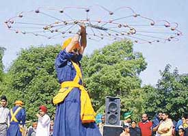 A Nihang shows his expertise in managing arms for self-defence