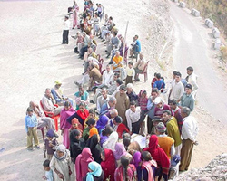 People wait for their turn at a free medical camp organised by the Hamirpur District Chemists and Druggists Association and the Rotary Club, at Jandroo village in Hamirpur on Sunday.