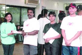 Mr India Prasad Kumar G presenting the Instructor Certification Programme certificates to successful candidates in the Capital in the presence of well-known trainer Nisha.