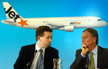 Geoff Dixon (R), Chief Executive Officer (CEO) of Qantas, Australia's biggest airline, listens to a question from Alan Joyce, CEO of the new low-cost Qantas carrier named Jetstar