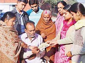 Students of GGDSD College, Sector 32, hand over a cheque for Rs 23,000 to