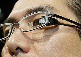 A Japanese man wears US MicroOptical's portable eyewear viewer