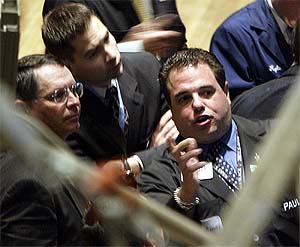 Traders work on the floor of the New York Stock Exchange