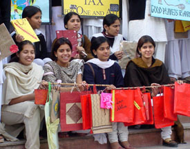 Students of Khalsa College for Women promote the use of paper bags during a rally against polythene