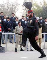 Members of the Indian polo team watch flag ceremony at the India-Pakistan border post of Wagah