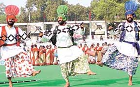 PUNJABI PANACHE: Folk dancers perform during the final day of Shastri Hockey Tournament in the Capital