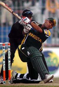 Pakistan's opener Imran Farhat hits a six as New Zealand wicketkeeper Brendon McCullum looks on
