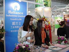 Two visitors stop at the Reliance Industries Limited stall at Chinaplas 2003