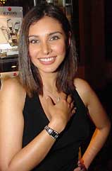 Indian model-turned actress Lisa Ray shows a watch by Rado in New Delhi on Tuesday.