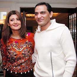 Former cricketer Mohammad Azharuddin with his wife, Sangita Bijlani, after she participated a walk on the ramp