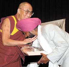 Dalai Lama gives away the Harmony Award in New Delhi on Wednesday to Master Ajit Singh, a philanthropist, who runs a school for orphans in Amritsars locality of widows. 