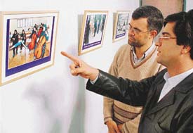 Local Iranian students discuss a photograph on the lives of Iranian women at the Department of Fine Arts, Panjab University.