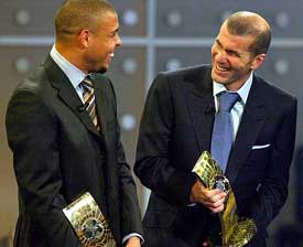 Zinedine Zidane of France, recipient  of the FIFA World Player 2003 award,  shares a joke with third placed Ronaldo of Brazil during the FIFA World Player of the Year awards in Basel