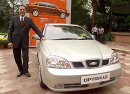 Managing Director of General Motors India Aditya Vij poses with the company's new Chevrolet Optra 1.6 car at a launch ceremony in New Delhi on Tuesday.