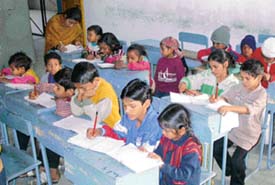 Children learn to write at a centre of the Sarv Shiksha Abhiyan at Government Model Senior Secondary School, Sector 33, in Chandigarh on Tuesday.
