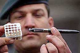 An Army officer displays chemical bullets and a Japanese pen pistol in Srinagar on Tuesday