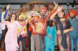 Punjabi singer Varinder Vij (centre) performs during the shooting of his music album Desi No. 1