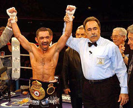 Mahyar Monshipour of France raises his arms after winning his bout against Venezuelan Jairo Tagliaferro