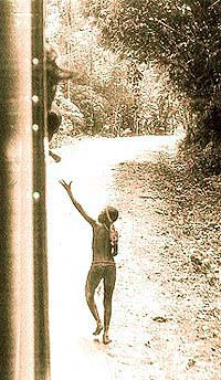 A Jarawa woman receiving food from a bus passenger