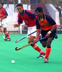 Players of Punjab Police and Border Security Force try to gain control of the ball in the seventh Farmtrac All-India Ramesh Chander Memorial Hockey Championship at Jalandhar