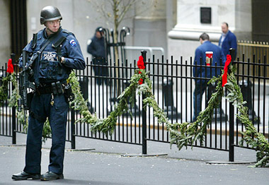 A New York police officer patrols the street outside the New York Stock Exchange