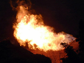 Fire pours out of the mouth of a natural gas well in China's southwestern municipality of Chongqing