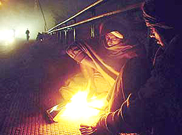 Small bonfires lit by the homeless help them pass cold winter nights out in the open