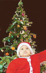 A young boy dressed as Santa Claus in Ludhiana on Thursday. 