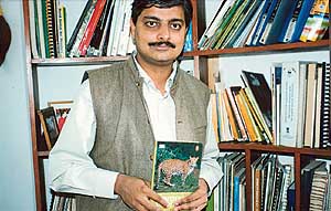 Vivek Menon with his book on mammals
