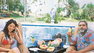 Living life king-size: Business baron-turned-politician Vijay Mallya with an international model at his beach-side villa in Goa