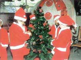 Students dressed up as Santa Claus at a Christmas celebration in Childrens Valley School, Preet Vihar.