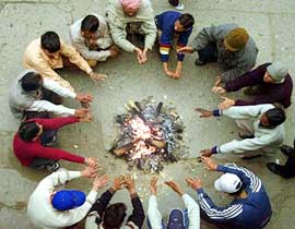 Men warm their hands over a fire in Amritsar on Sunday