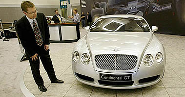Carsten F. Preisz, regional marketing manager, looks over the new Bentley Continental GT during a press preview of the Auto Show in Los Angeles