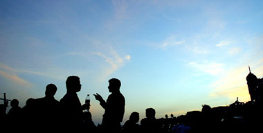 Pedestrian enjoy an evening stroll along a seaside promenade in Mumbai 
