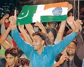 File photo of youths holding a joint flag of India and Pakistan at Wagha joint check post