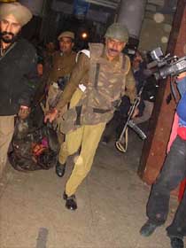 An injured civilian is taken away by the security forces in the militants' attack on Jammu railway station 