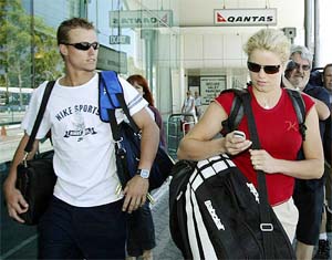 Australian tennis player Lleyton Hewitt (L) and his fiance Kim Clijsters of Belgium arrive at the airport in Perth